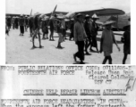 When the Japanese left the former Fourteenth Air Force Base at Liuchow, they left it heavily mined and pockmarked with bomb craters. Workers set out to repair the damage, while engineers of the Fourteenth Air Force, flown in by L-5s (in the background) survey the possibilities for quick repair.