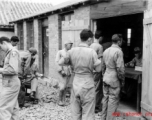 "'Stateside' folding money being handed out on payday by Lt. COl. John H. Williamson, CO of the Fourteenth Air Force Transport Unit to men of his command."