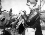 Sgt. Robert H. Zolbe, with kids in China (almost certainly Yunnan Province), handing out candy. Zolbe served in the 308th Bombardment Group, 425th Squadron on a B-24 bomber.