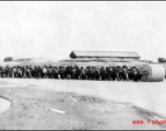 A crew of Chinese civilians pulling a roller at an air base in the CBI. During WWII.