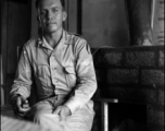 A GI sits and poses in a club in the CBI during WWII.    From the collection of David Firman, 61st Air Service Group.