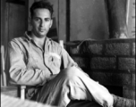 A GI sits and poses in a club in the CBI during WWII.    From the collection of David Firman, 61st Air Service Group.