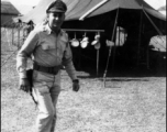 GI walks in front on a tent in India during WWII.  From the collection of David Firman, 61st Air Service Group.