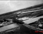 An aerial photograph of a railway bridge being bombed by the 491st Bomb Squadron in Yunnan or Indochina, during WWII.