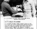 Sgt. Chang Lee Chen and Sgt. K. W. Ball make final adjustments to bomb for dive-bombing in the CACW during WWII in China.