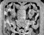 Traditional woodwork on door panels in China.