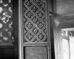 Traditional woodwork on door panels in China. During WWII.