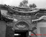 Architecture in Yunnan province, China during the Second World War: An ornate entry door to a home compound, during WWII.  From the collection of Eugene T. Wozniak.