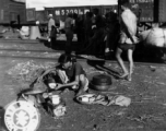 September 27, 1944  During WWII, a refugee from the Japanese Ichigo drive on Kweilin (Guilin) prepares her evening meal in the station at Liuchow, China.