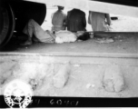 During WWII, a refugee from the advancing Japanese troops at Kweilin catches a nap under the wheels of a railroad car at the south station, Liuchow, China.