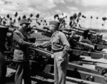 September 29, 1945    Kunming China L to R: Col. Hwang 13th Regt. C. O. shakes hands with Col. Charles Haggerty, American Liaison Officer (M. S.) to Chinese 13th F. A. Regt., with American artillery in the background. During WWII.   Photo by T/4 Henry Allen