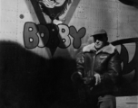 Combat Photographer Selig Seidler with the B-24 "Cocky Bobby" in the CBI.  Selig Seidler, combat photographer with the 16th Combat Camera Unit, in front of B-24 bomber #44-41427 COCKY BOBBY of the 14AF 308BG 425BS. From the collection of S/Sgt. Herbert Gross, 14AF 308BG 375BS, flight engineer/gunner on 42-73243 VITAMIN P II and other B-24s in China 1943-1944. (Shared by his son Jack Gross.)