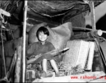 A refugee child rides a cart near around either Liuzhou or Guilin during the evacuation before the Japanese Ichigo advance in 1944, in Guangxi province.