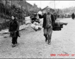 Refugees fleeing around either Liuzhou or Guilin carry possessions during the evacuation before the Japanese Ichigo advance in 1944, in Guangxi province.