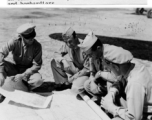 General Chennault on the flight line in conference with pilot officers, navigators, and bombardiers, while a camera crew catches it all in this contrived scene.