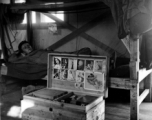 Barracks life at an American base in southwest China during WWII: Bunk, chest, and pin-ups.