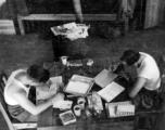 Barracks life at an American base in southwest China during WWII GIs take care of correspondence.  