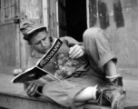GI reading a Photography magazine at an American installation in the CBI, during WWII.