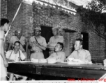 A Chinese prisoner being interrogated by the Chinese and Americans during WWII.