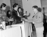 An American serviceman receiving gifts from Chinese civilian representatives in the CBI during WWII.