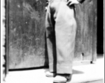 The Chinese child nicknamed "Little Tiger Joe" posing in doorway, during WWII.