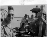 GI crosses Hoogly River in India, during WWII with fellow passengers and a bicycle.