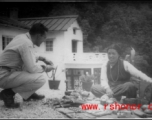 A GI talks to a local woman in the Himalayas, probably negotiating over prices for wares.    From "P. Noel" showing local people and scenes around Mussorie, India.    In the CBI during WWII. 