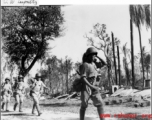 Chinese troops on the move in a wrecked area of Burma, during WWII.  Photo by C. W. Leipnitz.