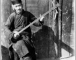 A man plays a three-string Chinese lute ( 三弦) in the CBI during WWII. 