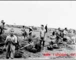 Roadside vendors sell vegetables in China during WWII.