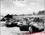 "Empty gas drums burned during raid." Karst hills in the background hit that this is likely a US base in Guangxi province, China, either at Liuzhou or Guilin.