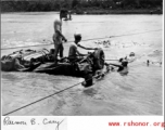 GIs float a jeep--wrapped in canvas to give it buoyancy--across the Moguang River in Burma, June 20, 1944.  Photo Raimon B. Cary. An identical image was submitted by Robert L. Cowan.