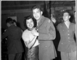 A young GI dances with an entrancing Chinese woman at a party and dance at the Hostel #10 Officer's Club on January 19, 1945. Another eager GI is reaching out to cut in, however.  Images provided by Dorothy Yuen Leuba.