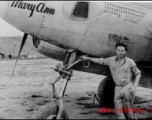 A man poses before the F-5 (a variant of the P-38) 'Mary Ann' piloted by Major H. T. Bailey, who had a crew chief "Snaffy".  Serial #43-26291.