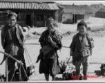 Three firewood peddlers in China during WWII.  Photo from Emery and Beth Vrana.