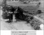 Chinese civilian washing clothes in ditch near Kunming, China, May 1945. Photo by Leipnitz.