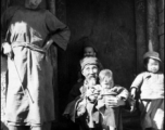 Village elders holds child in Yangkai village.  From the collection of Frank Bates.