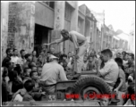 Capt. Grove campaigning for himself for mayor in a small town we passed through. Croughan on left, Capt. Penick on right.  Near an American base in Guangxi province (either Guilin or Liuzhou), China, during WWII.