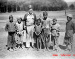 Walter Polchlopek with Chinese village kids in the area of Yangkai, Yunnan province, China, during WWII.