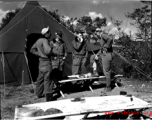 GIs talk and smoke in front of a tent at Qingshuihai lake.