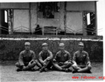 Chinese soldiers sit cross-legged in front of stage during rally in southern China, probably Yunnan province, or possibly in Burma.