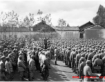 Chinese soldiers in dense formation listen to speech during rally.