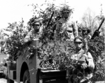 Chinese soldiers with equipment ready and covered in camouflage during exercises in southern China, in Yunnan province.  Despite the appearance of being on their way to battle, these men are more likely in fact prepared for a demonstration or honor parade. 