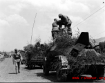 Chinese soldiers making final preparation on armored vehicles, and covered in camouflage during exercises in southern China, in Yunnan province.