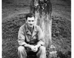 An image showing the GI photographer and collector of these photos (name unknown) sitting in front of a tomb, in Yunnan province, China.