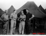 An image from the Roubinek Collection, showing American GIs and street scenes in India: GIs play music in front of tent in India.