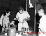 Americans and Chinese work together to provide medical treatment during WWII in China.  Note the sick Chinese man on the floor.