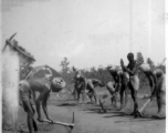 Workers dig up a well-driven surface.  Scenes in India witnessed by American GIs during WWII. For many Americans of that era, with their limited experience traveling, the everyday sights and sounds overseas were new, intriguing, and photo worthy.