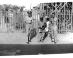 GIs pose with musician and child.  Scenes in India witnessed by American GIs during WWII. For many Americans of that era, with their limited experience traveling, the everyday sights and sounds overseas were new, intriguing, and photo worthy.